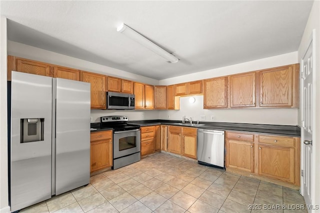 1629 Timber Creek Dr Unit 1629, Columbia, MO 65202 - kitchen with appliances with stainless steel finishes, dark countertops, and light tile patterned floors