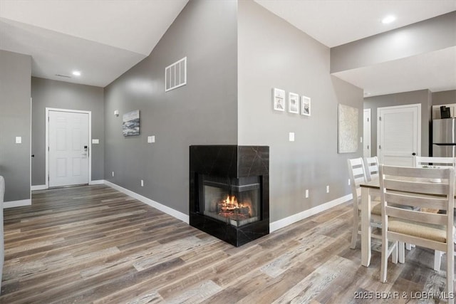 576 Racquet Club Dr Unit 407, Lake Ozark, MO 65049 - living room with wood finished floors, a tile fireplace, and recessed lighting