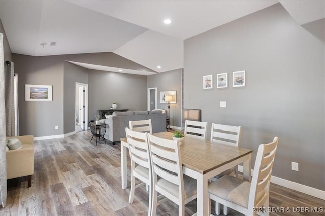 576 Racquet Club Dr Unit 407, Lake Ozark, MO 65049 - dining space featuring wood finished floors and vaulted ceiling