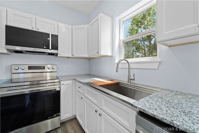 40 Walnut Ct, Eldon, MO 65026 - kitchen with stainless steel appliances, white cabinetry, and light stone countertops