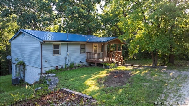 124 Frontier Cir, Linn Creek, MO 65052 - rear view of property with covered porch, a lawn, and a metal roof