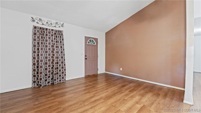124 Frontier Cir, Linn Creek, MO 65052 - spare room featuring wood finished floors and vaulted ceiling