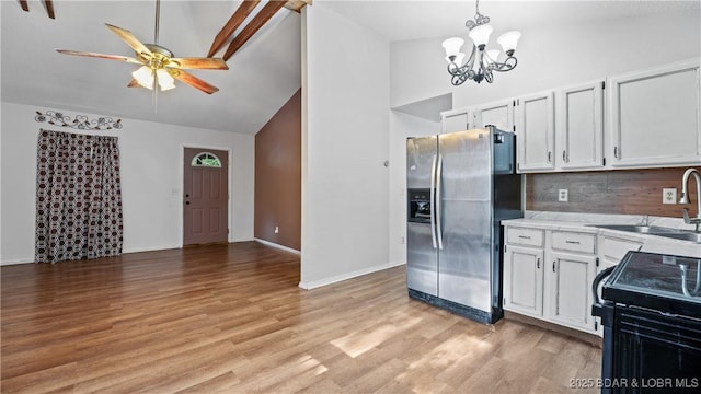 124 Frontier Cir, Linn Creek, MO 65052 - kitchen featuring stainless steel fridge, black / electric stove, backsplash, a chandelier, and light wood finished floors