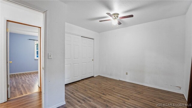 124 Frontier Cir, Linn Creek, MO 65052 - unfurnished bedroom featuring wood finished floors, a closet, and ceiling fan