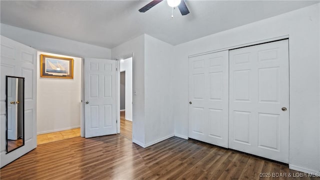124 Frontier Cir, Linn Creek, MO 65052 - unfurnished bedroom with dark wood-style floors, a closet, and a ceiling fan