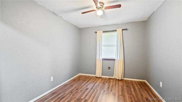 124 Frontier Cir, Linn Creek, MO 65052 - empty room with a ceiling fan and wood finished floors