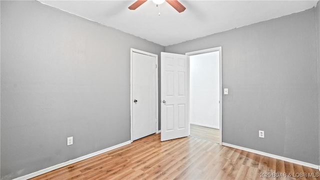 124 Frontier Cir, Linn Creek, MO 65052 - unfurnished bedroom with wood finished floors and a ceiling fan