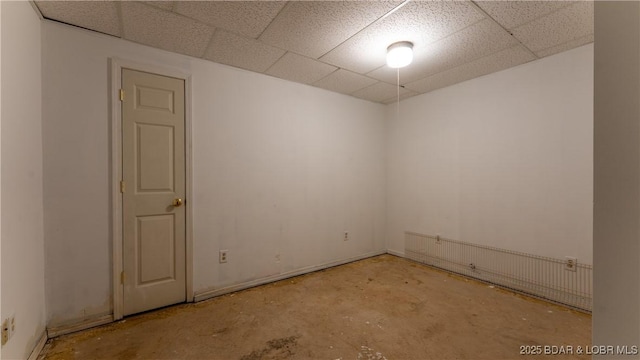 124 Frontier Cir, Linn Creek, MO 65052 - empty room featuring a paneled ceiling and concrete flooring