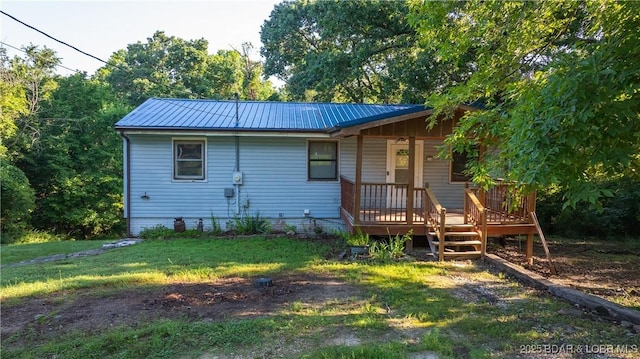 124 Frontier Cir, Linn Creek, MO 65052 - back of property featuring a porch, a yard, and a metal roof