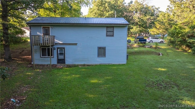 124 Frontier Cir, Linn Creek, MO 65052 - rear view of house featuring a yard and a metal roof