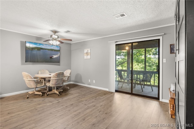19 Catalpa Ct Unit 2C, Lake Ozark, MO 65049 - dining area with crown molding, a textured ceiling, wood finished floors, and a ceiling fan