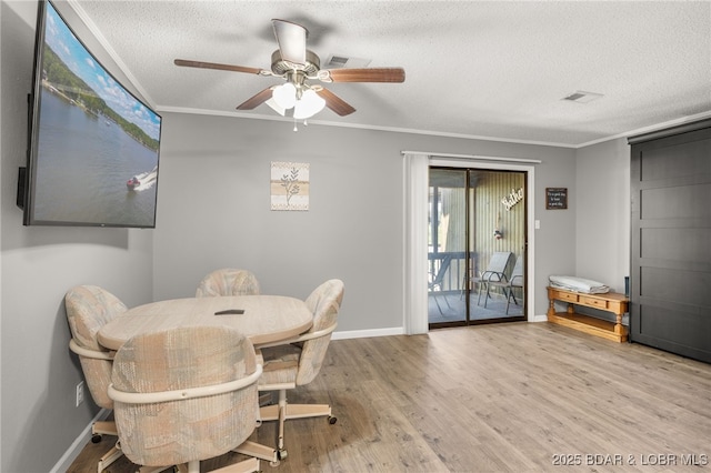 19 Catalpa Ct Unit 2C, Lake Ozark, MO 65049 - dining room with a textured ceiling, a ceiling fan, ornamental molding, and wood finished floors