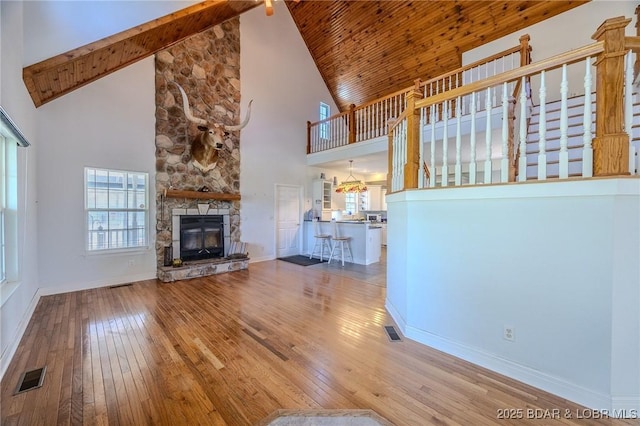 1480 Copperstone Rd, Camdenton, MO 65020 - unfurnished living room featuring high vaulted ceiling, hardwood / wood-style flooring, a fireplace, and a wood ceiling with exposed beams