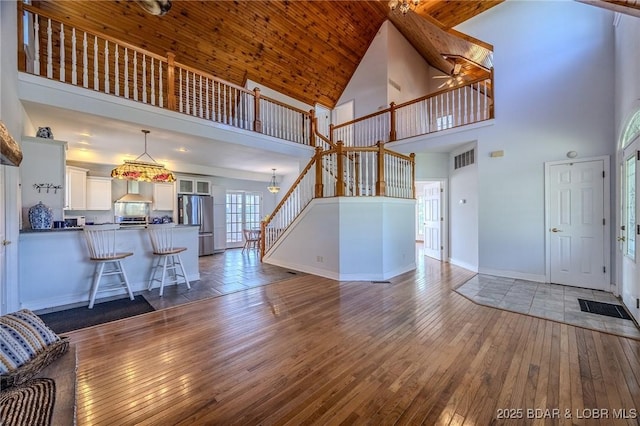 1480 Copperstone Rd, Camdenton, MO 65020 - living room featuring high vaulted ceiling, hardwood / wood-style flooring, a ceiling fan, and stairway