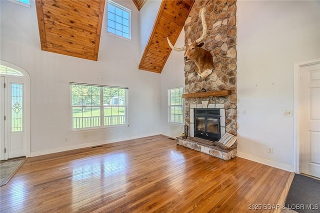 1480 Copperstone Rd, Camdenton, MO 65020 - unfurnished living room with high vaulted ceiling, hardwood / wood-style flooring, and a stone fireplace