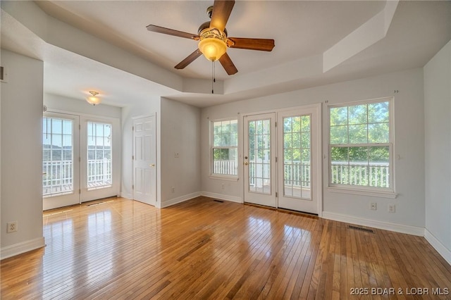 1480 Copperstone Rd, Camdenton, MO 65020 - unfurnished room with hardwood / wood-style flooring, ceiling fan, and a tray ceiling