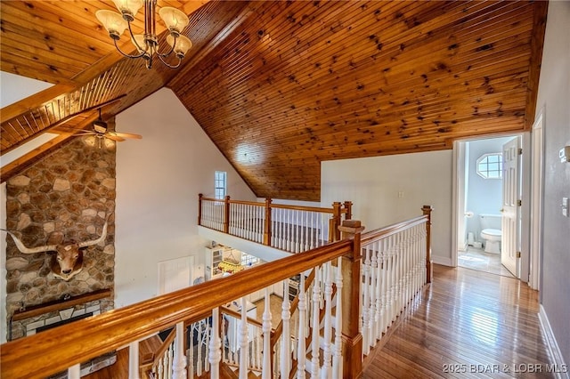 1480 Copperstone Rd, Camdenton, MO 65020 - hall with an upstairs landing, vaulted ceiling, a chandelier, wooden ceiling, and wood finished floors