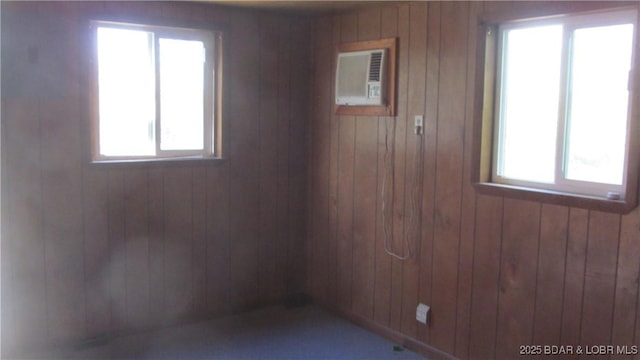 87 Central Ozarks Rd, Edwards, MO 65326 - unfurnished room with wooden walls, plenty of natural light, and a wall mounted air conditioner