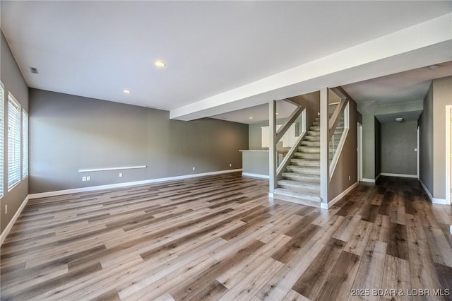 893 Winetavern Rd, Osage Beach, MO 65065 - unfurnished living room with stairway, wood finished floors, and recessed lighting