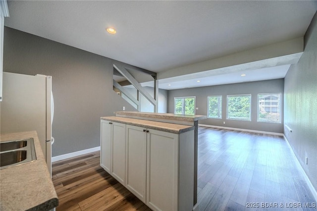 893 Winetavern Rd, Osage Beach, MO 65065 - kitchen featuring wood finished floors, open floor plan, light countertops, white cabinetry, and recessed lighting
