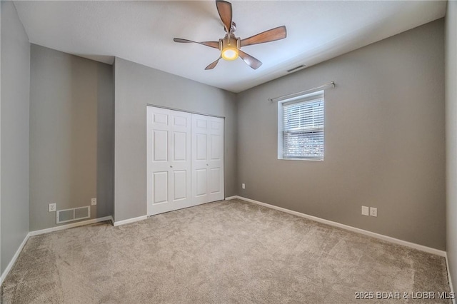 893 Winetavern Rd, Osage Beach, MO 65065 - unfurnished bedroom featuring carpet flooring, a closet, and a ceiling fan