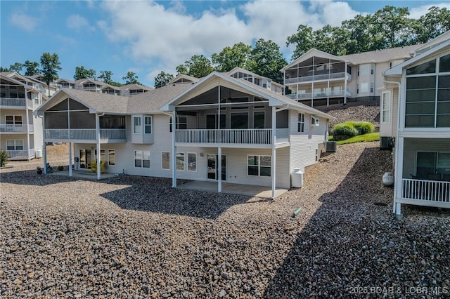 893 Winetavern Rd, Osage Beach, MO 65065 - back of house featuring a sunroom and a patio