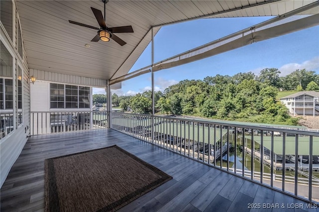 893 Winetavern Rd, Osage Beach, MO 65065 - deck with ceiling fan and view of wooded area