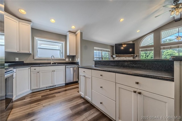 893 Winetavern Rd, Osage Beach, MO 65065 - kitchen with stainless steel dishwasher, wood finished floors, white cabinets, a ceiling fan, and dark countertops