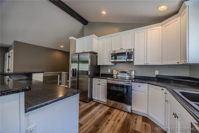 893 Winetavern Rd, Osage Beach, MO 65065 - kitchen featuring appliances with stainless steel finishes, wood finished floors, white cabinetry, and recessed lighting