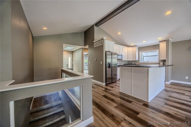 893 Winetavern Rd, Osage Beach, MO 65065 - kitchen featuring stainless steel appliances, wood finished floors, white cabinetry, dark countertops, and recessed lighting