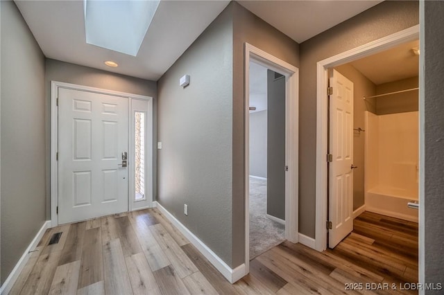 893 Winetavern Rd, Osage Beach, MO 65065 - foyer entrance with light wood finished floors, a skylight, and recessed lighting