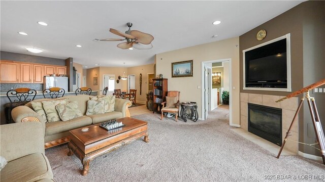 1230 Lands End Pkwy Unit 304, Osage Beach, MO 65065 - living room with a ceiling fan, light carpet, a tile fireplace, and recessed lighting