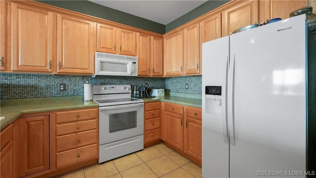 1230 Lands End Pkwy Unit 304, Osage Beach, MO 65065 - kitchen featuring white appliances, light tile patterned floors, tasteful backsplash, and light countertops