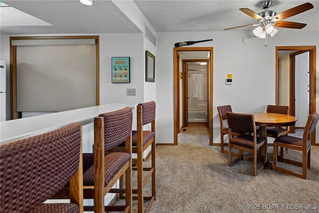 278 Lone Oak Pt Unit 18, Sunrise Beach, MO 65079 - dining room with light colored carpet, ceiling fan, and a textured ceiling
