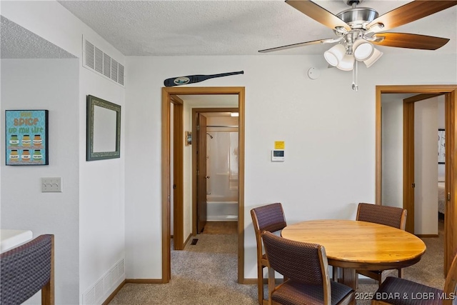278 Lone Oak Pt Unit 18, Sunrise Beach, MO 65079 - dining room with light carpet, ceiling fan, and a textured ceiling