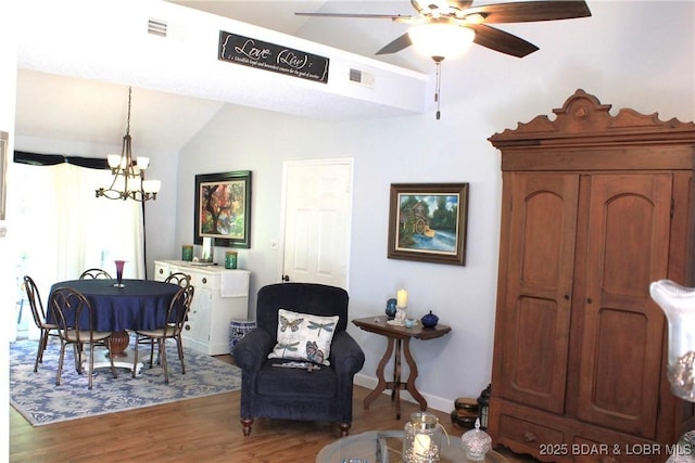 891 Azalea Ct, Osage Beach, MO 65065 - dining room with a ceiling fan, wood finished floors, a chandelier, and lofted ceiling