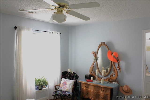 891 Azalea Ct, Osage Beach, MO 65065 - living area with a textured ceiling, a ceiling fan, and plenty of natural light