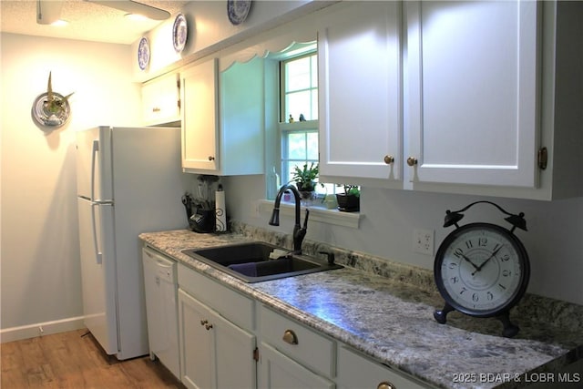 891 Azalea Ct, Osage Beach, MO 65065 - kitchen featuring white dishwasher, light wood-style floors, and white cabinets