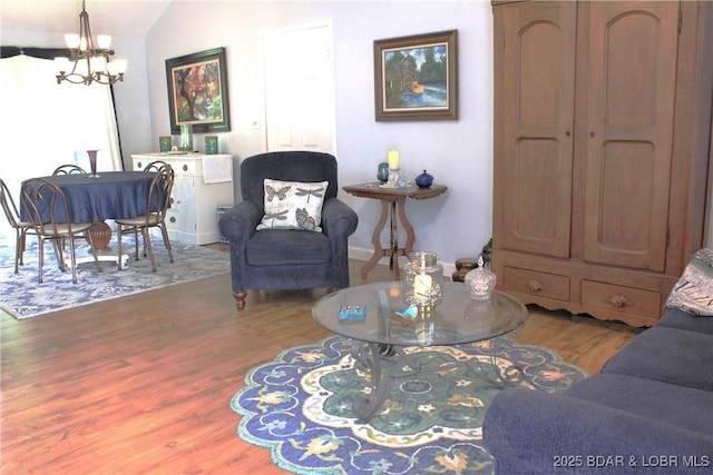 891 Azalea Ct, Osage Beach, MO 65065 - living room with wood finished floors, a chandelier, and vaulted ceiling