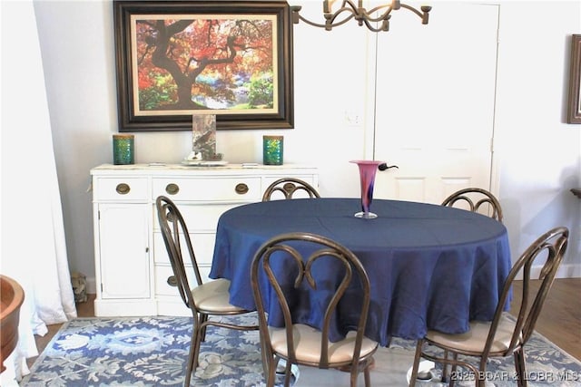 891 Azalea Ct, Osage Beach, MO 65065 - dining area featuring a chandelier and wood finished floors