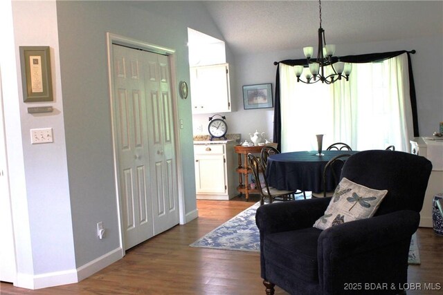 891 Azalea Ct, Osage Beach, MO 65065 - living room with a chandelier, dark wood-type flooring, and vaulted ceiling