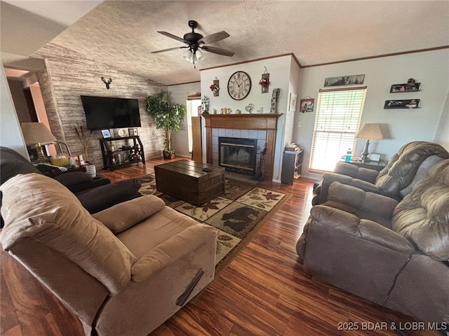 17362 Country Life Rd, Gravois Mills, MO 65037 - living room with a ceiling fan, a tile fireplace, wood finished floors, vaulted ceiling, and a textured ceiling