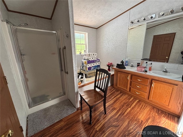 17362 Country Life Rd, Gravois Mills, MO 65037 - bathroom featuring crown molding, wood finished floors, a shower stall, double vanity, and a textured wall