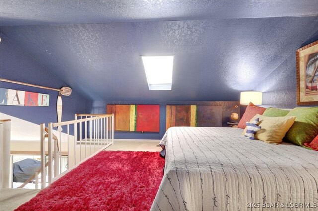 2500 Bay Point Ln Unit 444, Osage Beach, MO 65065 - bedroom with vaulted ceiling, a textured ceiling, and carpet