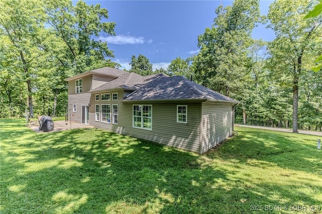 326 Bloomington Dr, Four Seasons, MO 65049 - view of property exterior with a patio area, a lawn, and a shingled roof