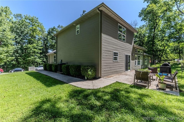 326 Bloomington Dr, Four Seasons, MO 65049 - view of home's exterior featuring a patio area and a lawn