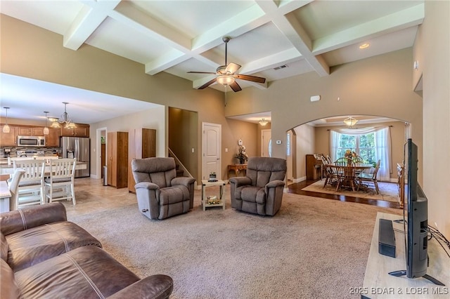326 Bloomington Dr, Four Seasons, MO 65049 - living room with arched walkways, coffered ceiling, a ceiling fan, beamed ceiling, and a high ceiling