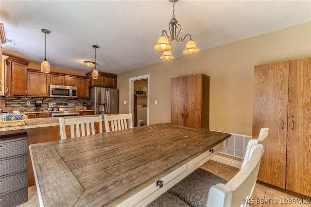 326 Bloomington Dr, Four Seasons, MO 65049 - dining room featuring a chandelier and light tile patterned floors