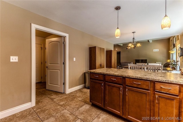 326 Bloomington Dr, Four Seasons, MO 65049 - kitchen with hanging light fixtures, light tile patterned floors, and open floor plan