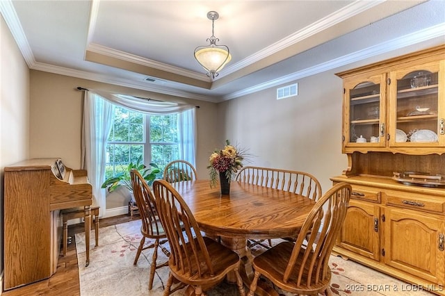 326 Bloomington Dr, Four Seasons, MO 65049 - dining area with light wood-style flooring, crown molding, and a raised ceiling